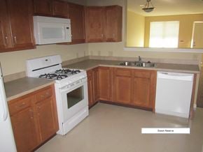 S. Glens Falls townhouse for rent - an empty kitchen with white appliances and wooden cabinets