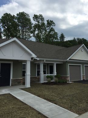 S. Glens Falls townhouse for rent - a white and green house with white pillars and a sidewalk