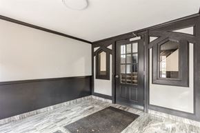 Chicago apartment for rent - the living room of a house with black and white walls and a door