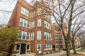 Chicago apartment for rent - a red brick building with trees in front of it