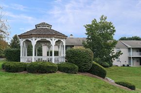 Harrisburg apartment for rent - a white gazebo on a lawn in front of a house