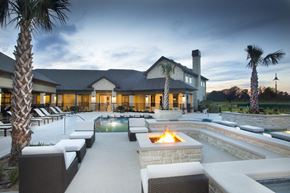 Lake Charles apartment for rent - a swimming pool with a fire pit in front of a house