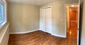 South Portland apartment for rent - A room with a white door and a wooden floor.