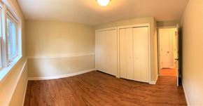 South Portland apartment for rent - A room with a wooden floor and white walls with a doorway leading to another room.