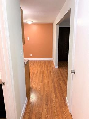 South Portland apartment for rent - A hallway with a wooden floor and white walls.