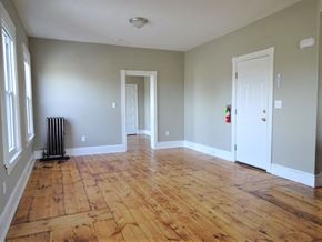 Portland apartment for rent - A room with wood flooring and white walls.