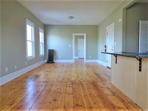Portland apartment for rent - A room with wooden floors and a black counter.