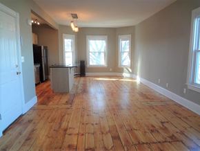 Portland apartment for rent - A room with wooden floors and white walls.