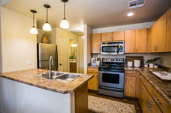 Versante apartments gourmet kitchens with stainless steel appliances
