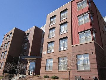 Denver apartment for rent - A red brick building with a tree in front.
