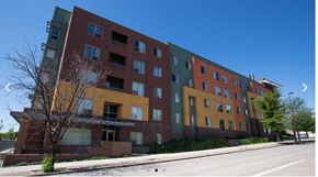 Denver apartment for rent - A multi-story building with a mix of red and yellow facades.