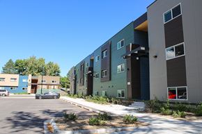 Lakewood apartment for rent - A parking lot in front of a building with a car parked.