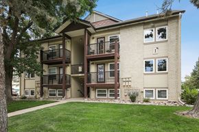 Lakewood apartment for rent - Apartment building with balconies and a green lawn in front.