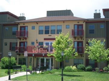 Lakewood apartment for rent - A building with a red balcony in the front.
