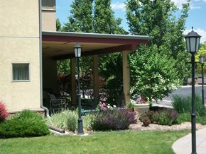 Lakewood apartment for rent - A house with a red roof and a porch with a lamp post.