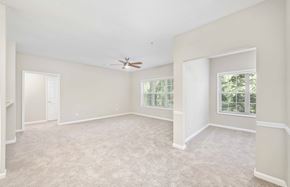 Atlanta apartment for rent - an empty living room with a ceiling fan and a window