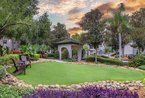 Tampa apartment for rent - a garden with a green lawn and a gazebo