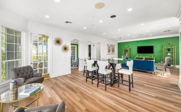 Tampa apartment for rent - a living room with green walls and a dining room with a table and chairs