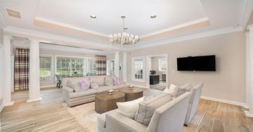 Centreville apartment for rent - A living room with a grey couch and a chandelier.