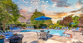Centreville apartment for rent - A poolside area with chairs and umbrellas is shown.