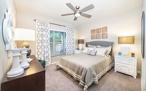 Smyrna apartment for rent - a bedroom with a large bed and a ceiling fan