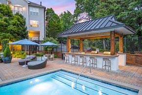 Atlanta apartment for rent - A pool area with a bar and seating area.