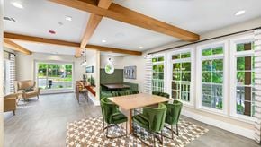 Atlanta apartment for rent - A dining room with a wooden table and green chairs.