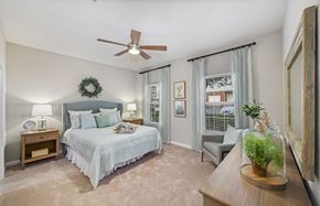 Charlotte apartment for rent - a bedroom with a bed and a ceiling fan