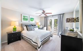 Atlanta apartment for rent - a bedroom with a large bed and a ceiling fan