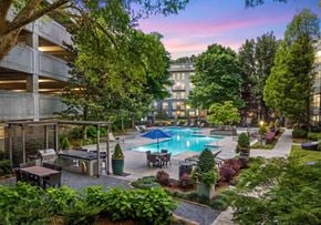 Atlanta apartment for rent - A pool surrounded by trees and plants.