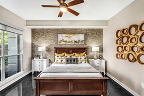 Atlanta apartment for rent - A bedroom with a bed, nightstands, and a ceiling fan.