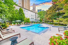 Atlanta apartment for rent - a swimming pool at a hotel with a city in the background