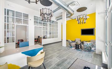 Atlanta apartment for rent - a living room with a yellow wall and white and gray furniture