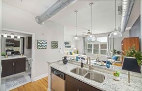 Charlotte apartment for rent - an open kitchen and living room with a kitchen island and a sink