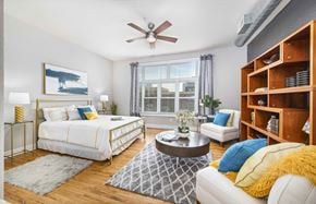 Charlotte apartment for rent - a bedroom with a bed and a ceiling fan