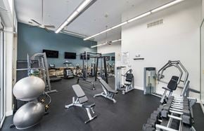 Charlotte apartment for rent - a gym with weights and cardio equipment and a tv