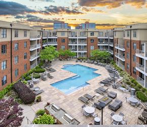 Charlotte apartment for rent - an overhead view of a swimming pool in front of an apartment building
