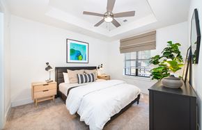 Charlotte apartment for rent - a bedroom with a large bed and a ceiling fan