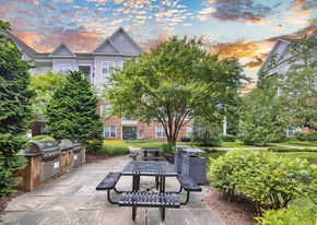 Rockville apartment for rent - a courtyard with picnic tables and benches in front of a building