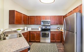 Charlotte apartment for rent - a kitchen with stainless steel appliances and granite counter tops
