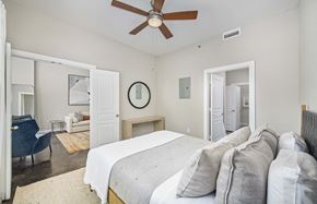 Charlotte apartment for rent - a bedroom with a large bed and a ceiling fan