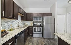Charlotte apartment for rent - a kitchen with stainless steel appliances and marble counter tops