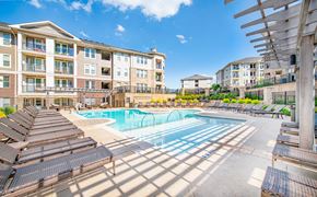 Raleigh apartment for rent - our apartments have a large pool and lounge chairs in front of our building