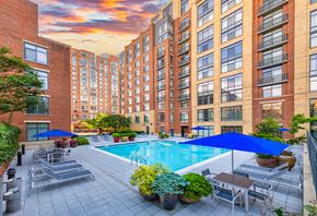 Alexandria apartment for rent - a swimming pool in the middle of a building with chairs and umbrellas
