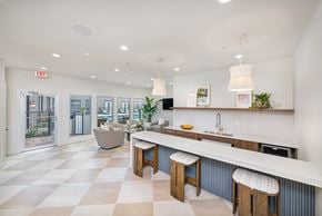 Dallas apartment for rent - A kitchen with a checkered floor and a bar area.