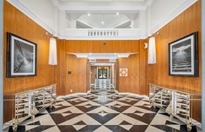 Dallas apartment for rent - a conference room with a checkered floor and tables with chairs