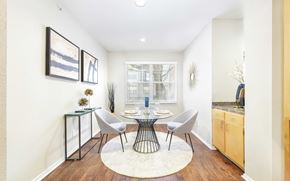Dallas apartment for rent - A dining room with a table set for two and a white rug on the floor.