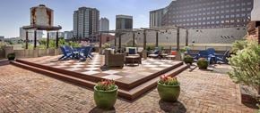 Dallas apartment for rent - a patio with chairs and tables on a brick patio