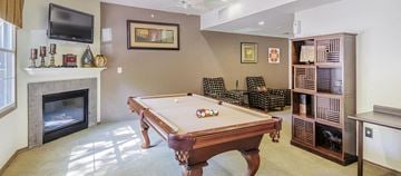 Dallas apartment for rent - a living room with a pool table and a fireplace