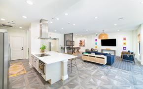 Dallas apartment for rent - a white kitchen and living room with a large white counter top and a kitchen island
